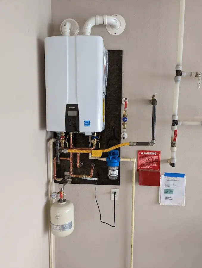 Professional plumber installing copper piping in a Pocopson home